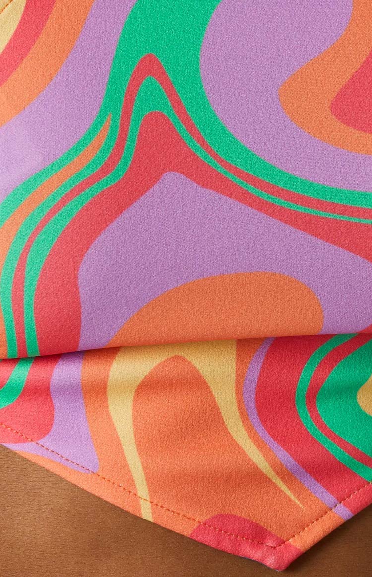 Close-up of the multi-coloured swirly pattern fabric in green, red, purple, orange, and yellow