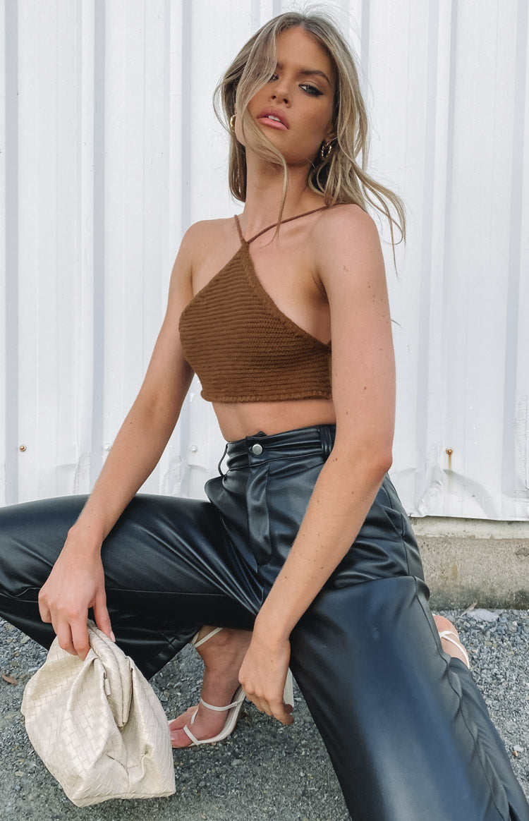 Brown crochet halter top with thin spaghetti straps and a cropped hem