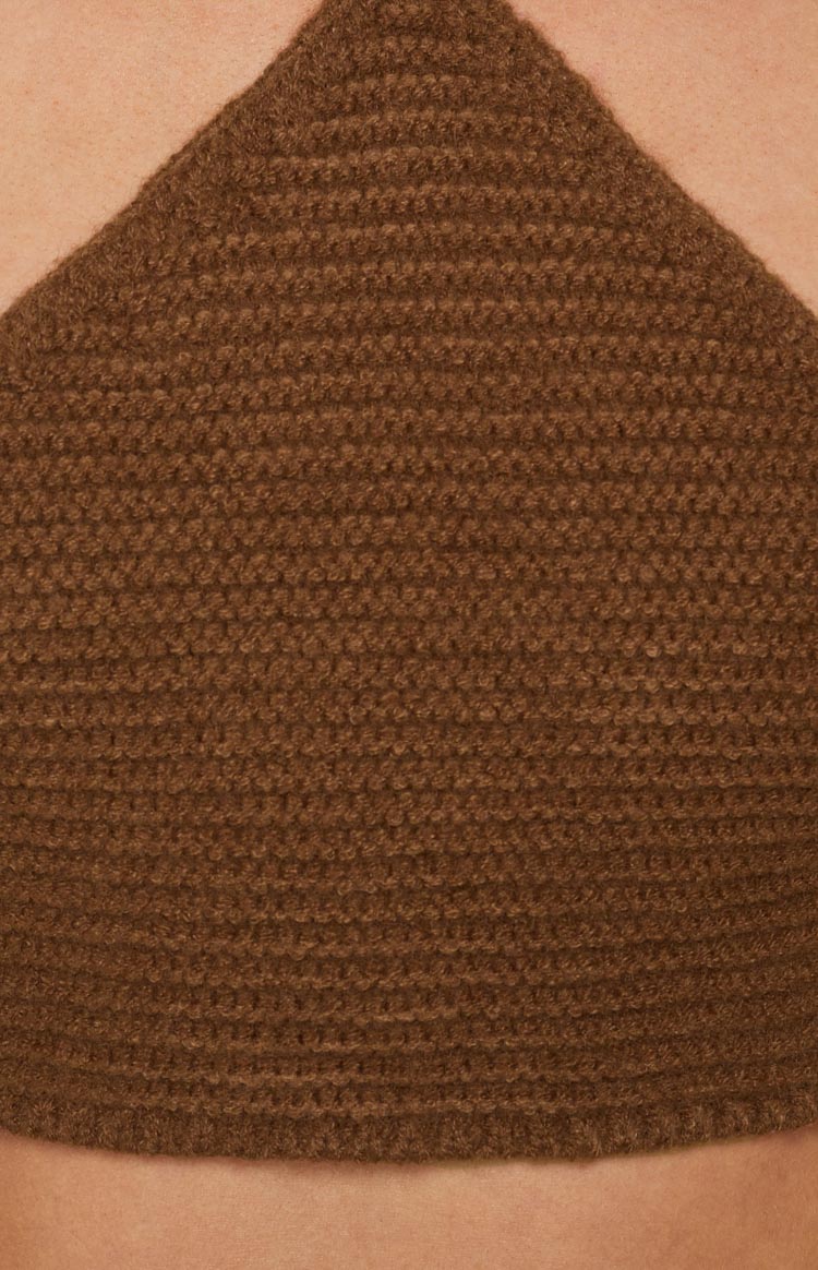 Close-up of the brown crochet knit fabric with a textured stitch pattern