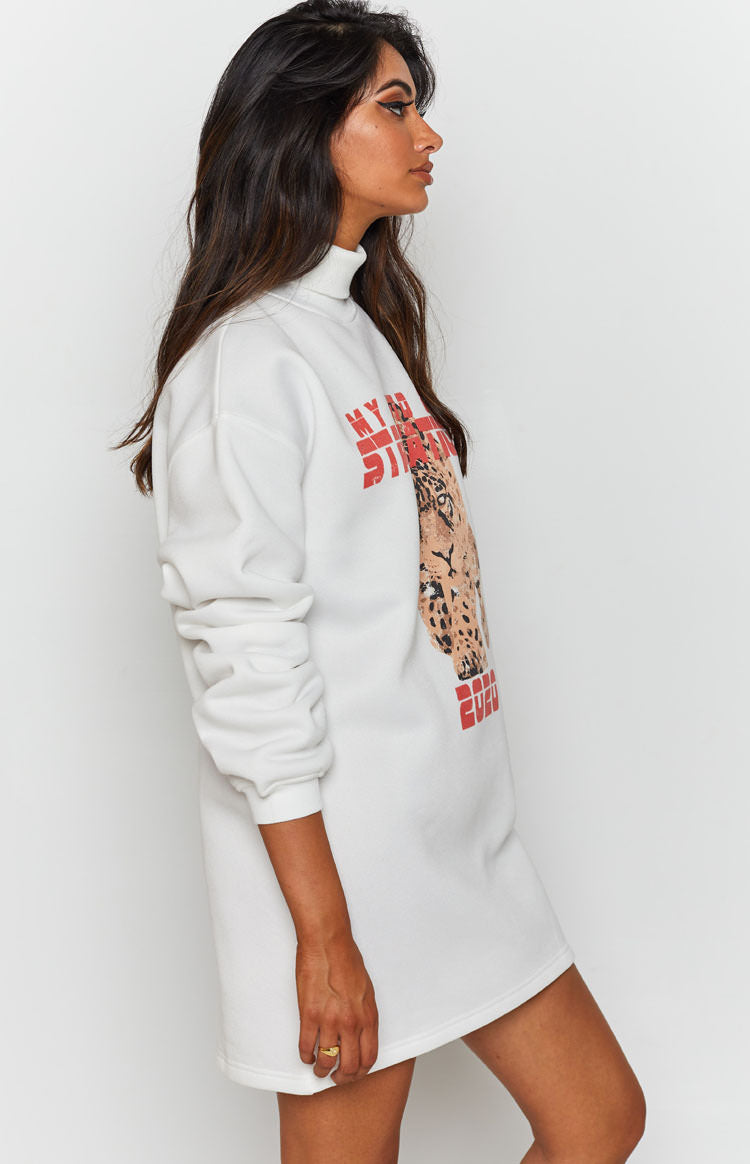 White turtleneck sweater dress with long cuffed sleeves and a front leopard head graphic print