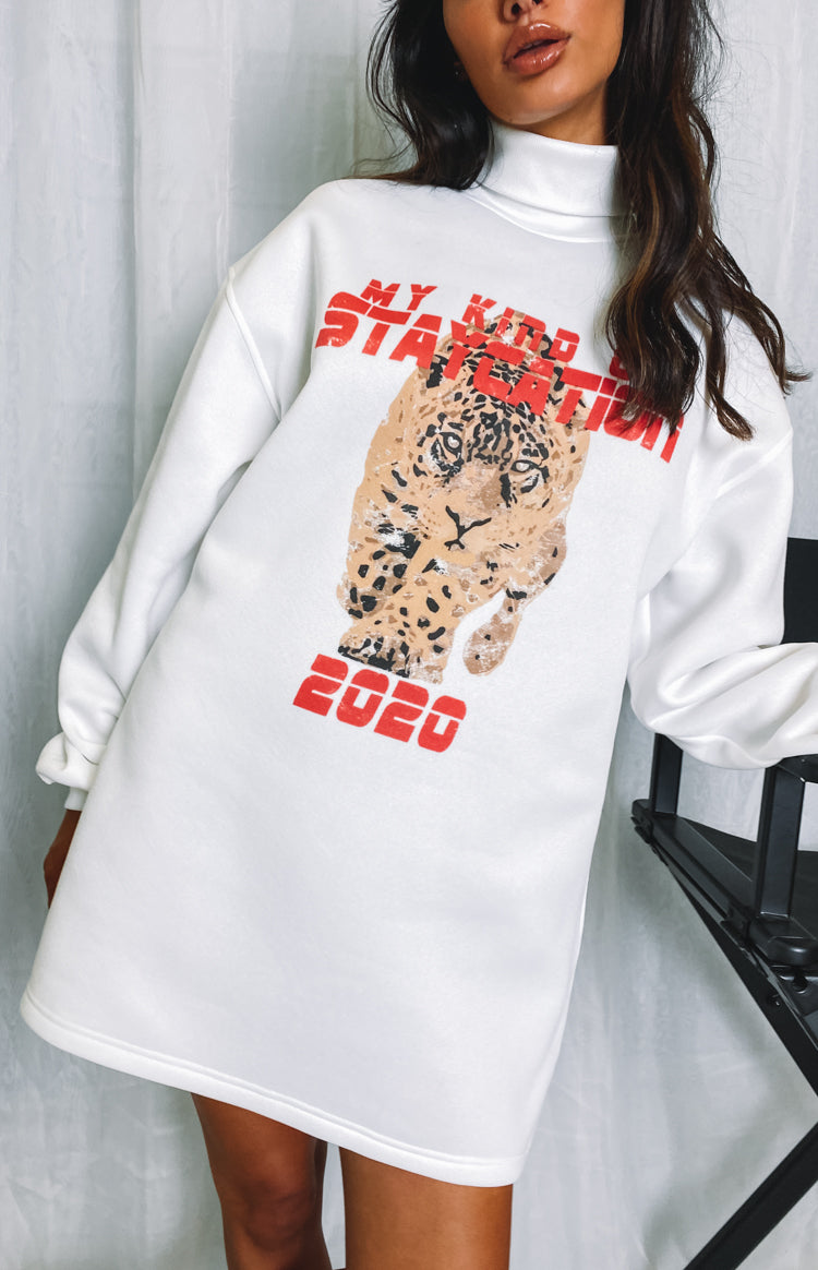 White oversized turtleneck sweater dress with a large leopard graphic print and red text