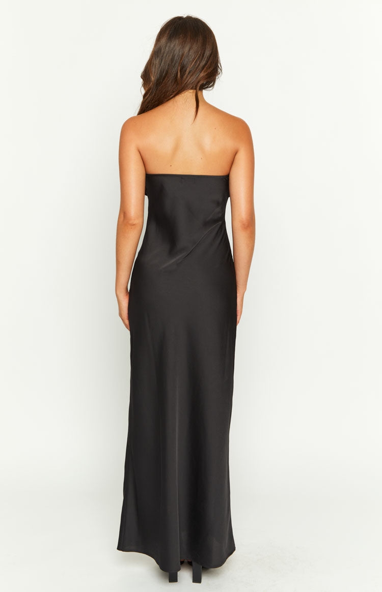 Rear view of a black strapless maxi dress with a straight-across back and a flowing skirt