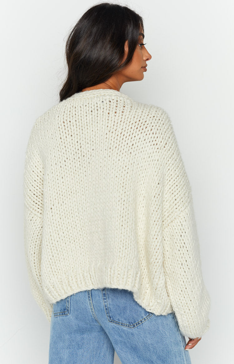 Side and rear view of the cream chunky knit cardigan showing its relaxed fit and ribbed hem