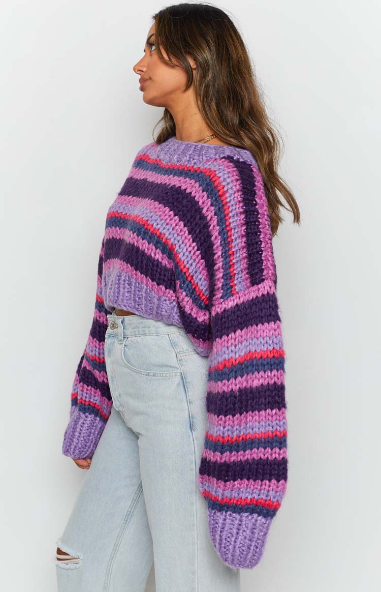 Chunky knit sweater with horizontal purple, pink, and blue stripes, relaxed fit and long ribbed cuffs
