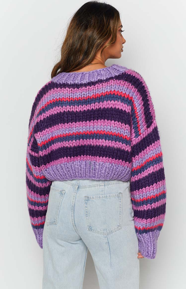Chunky knit sweater with wide purple, pink, and blue horizontal stripes, a ribbed neckline, and cropped hem