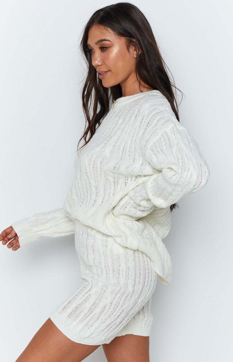 Cream cable knit shorts with intricate openwork patterns, part of a matching textured knit set