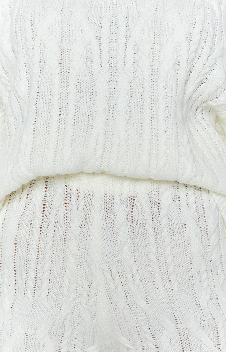 Cream cable knit shorts with intricate open weave and textured cable patterns