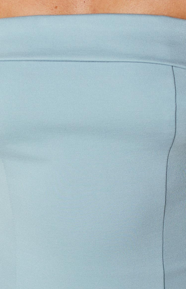 Close-up of the light blue mini dress fabric showing a vertical seam and the folded top edge