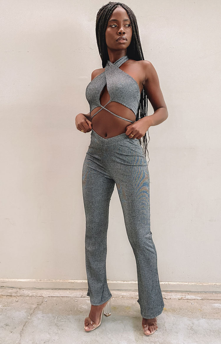 Black ribbed flared pants featuring a V-shaped waistband and a subtle metallic shimmer