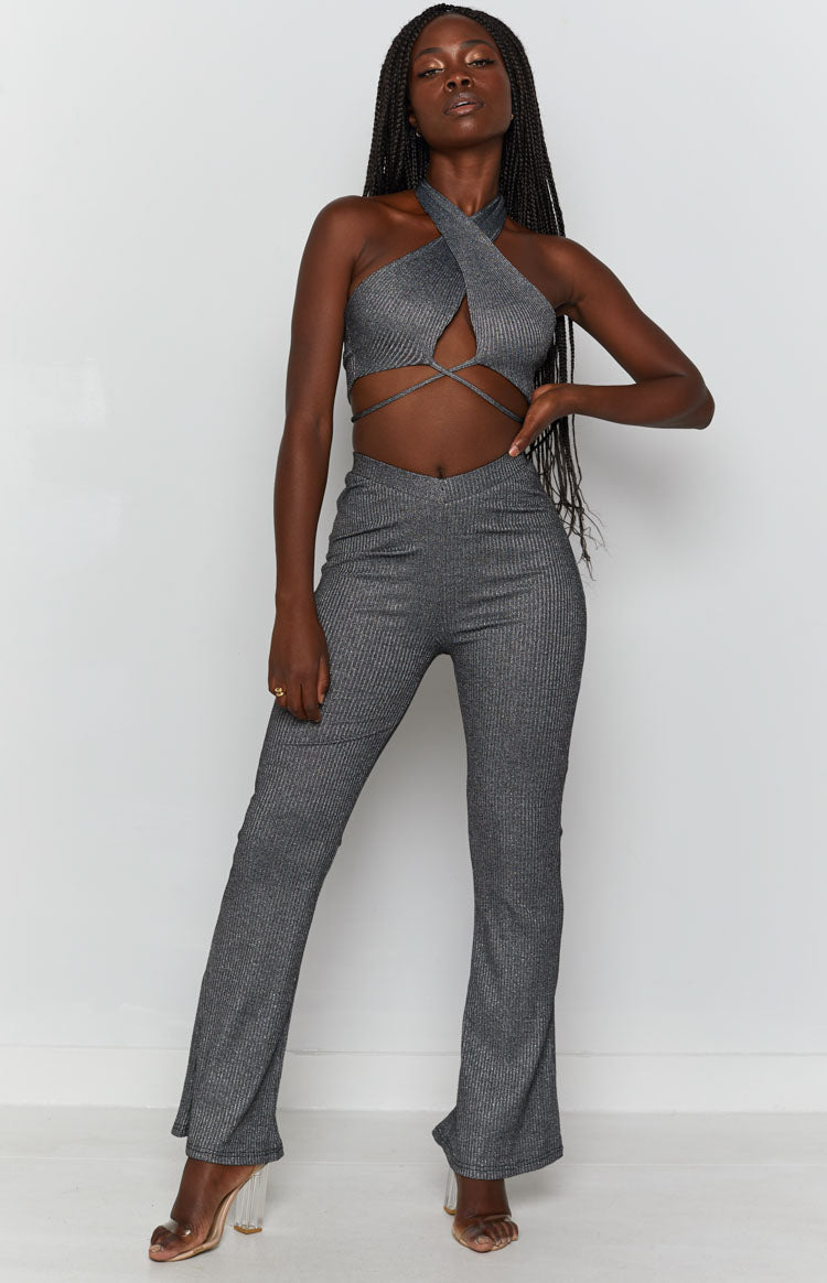 Shimmering silver ribbed Cher Rib Pants with a V-waistband and subtle flare, worn with a matching halter crop top