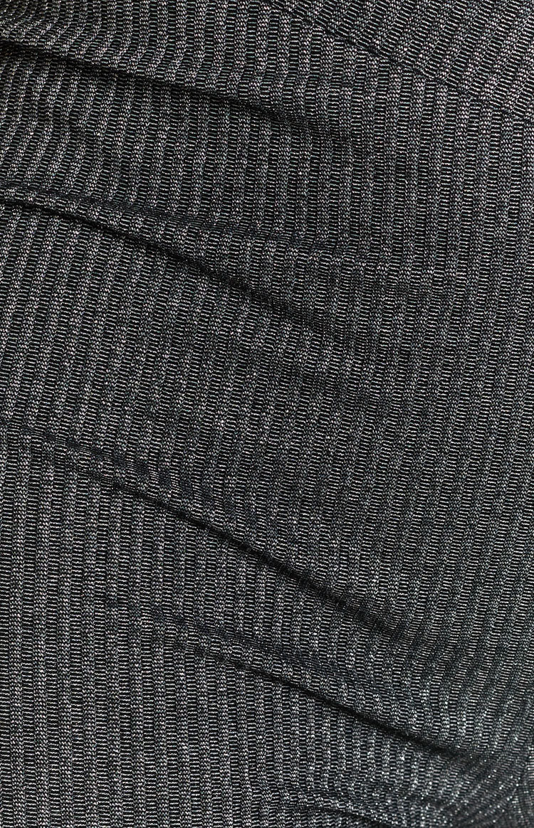Black ribbed knit fabric showing fine vertical texture and soft folds