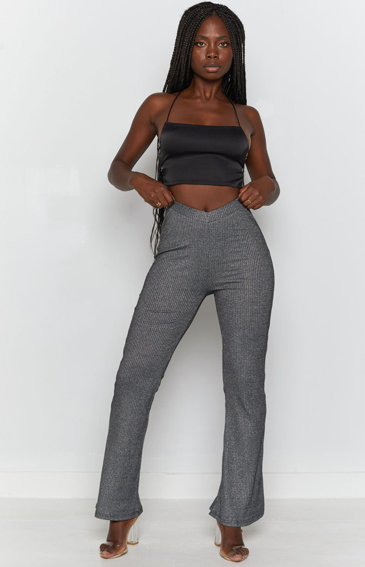 Black ribbed knit pants with a high V-front waistband and a subtle flared leg