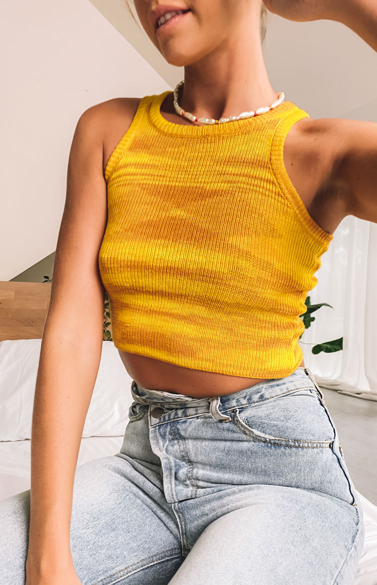 Yellow ribbed knit tank top with horizontal orange stripes and a crew neckline