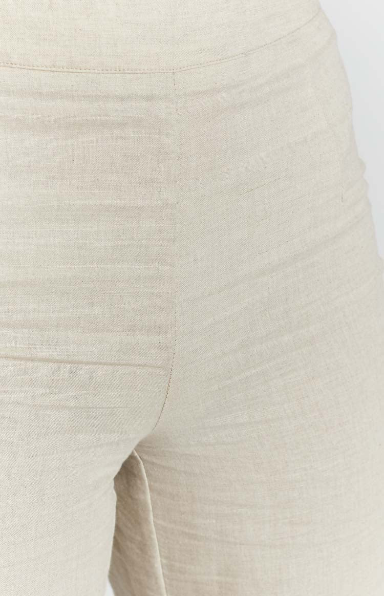 Beige linen blend pants with a natural slub texture and visible waistband seam