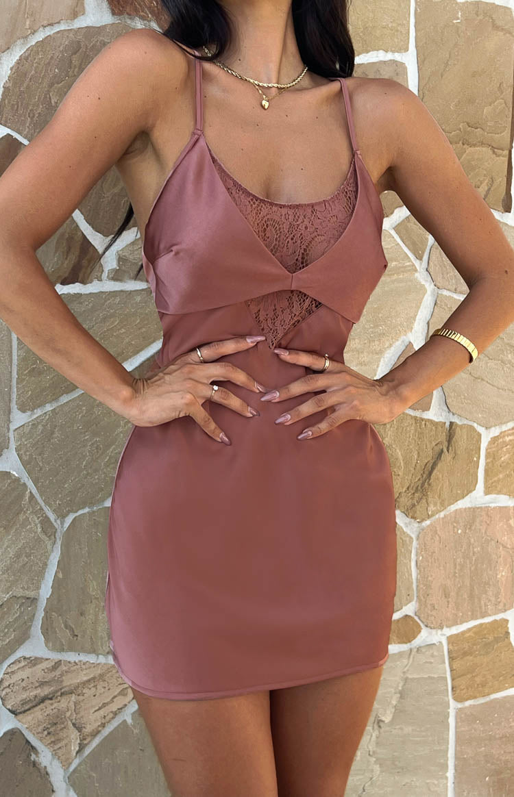 Close-up of the V-neckline with a lace insert and fitted waist detail on a brown slip mini dress