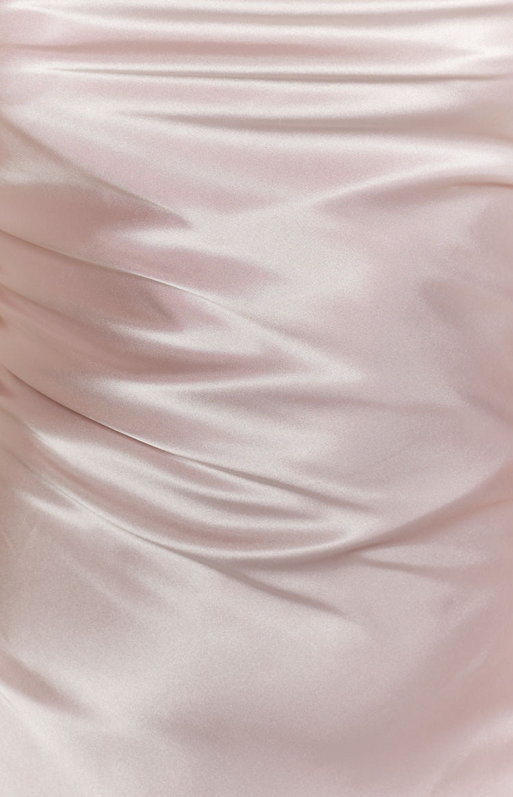 Blush pink satin fabric with soft, flowing drapes and a subtle sheen