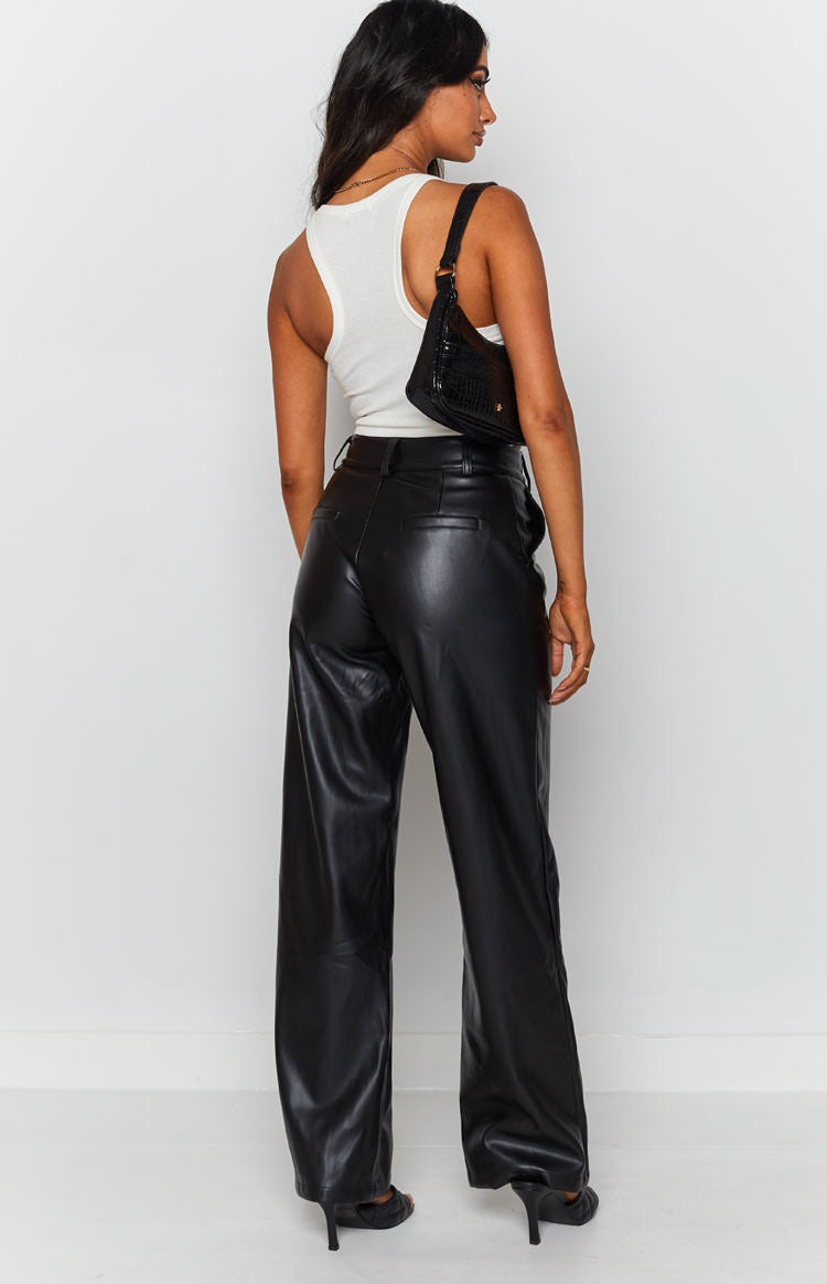 High waisted black PU pants featuring a wide leg silhouette and back pockets