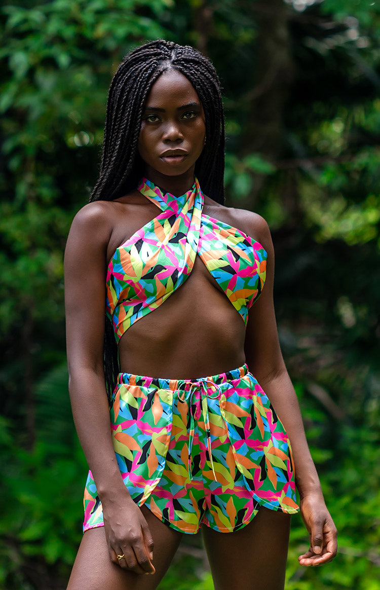 Bright tropical leaf print two-piece set with a criss-cross halter crop top and wrap shorts