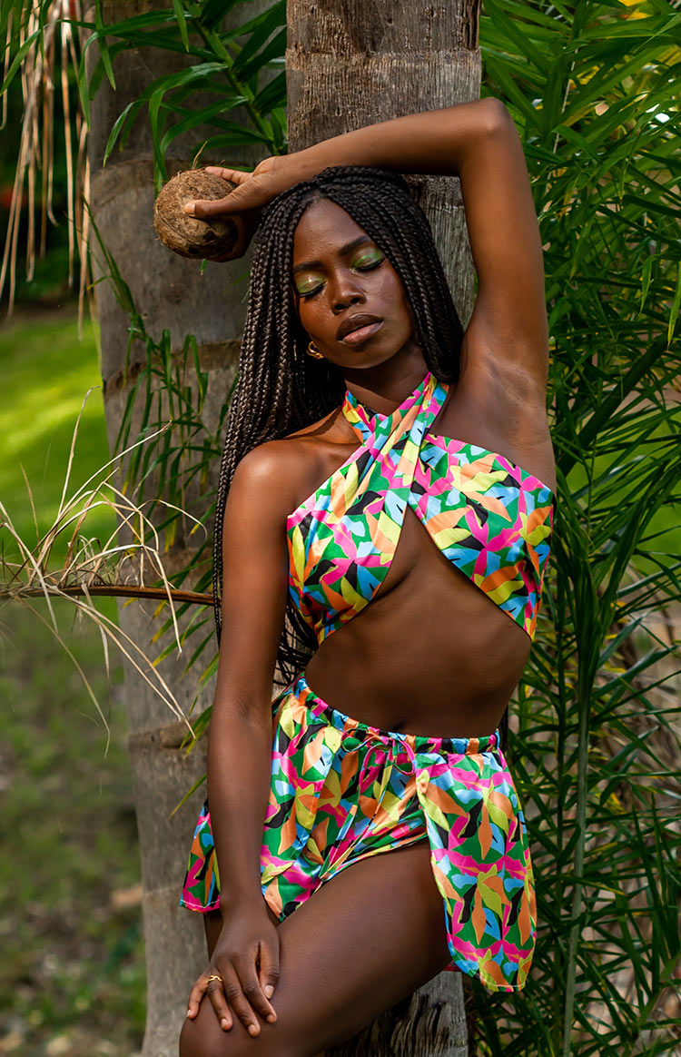 Bright tropical leaf print mini wrap shorts with a drawstring waist, matching criss-cross halter crop top