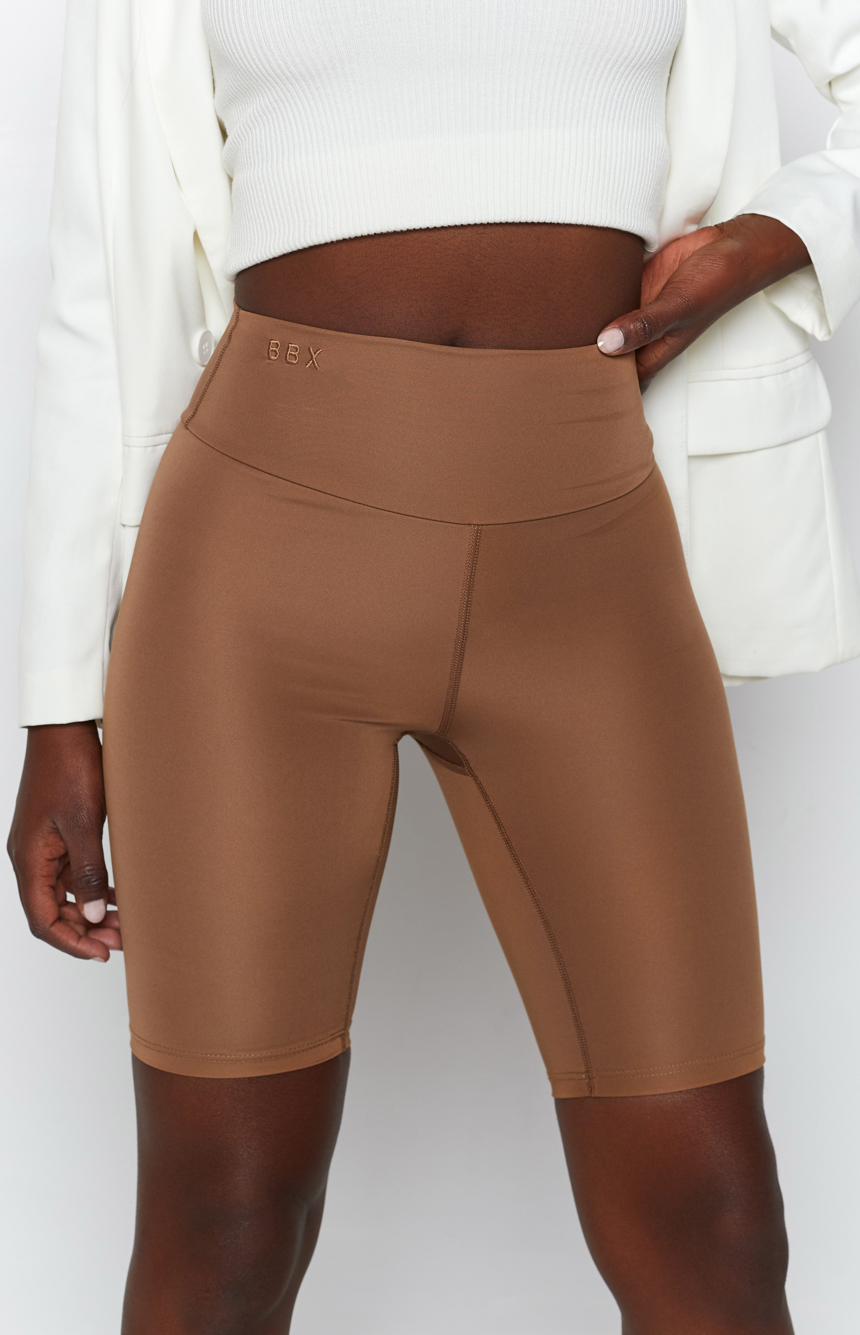 Toffee high-waisted bike shorts with BBX logo embroidery on the waistband and visible flatlock seams
