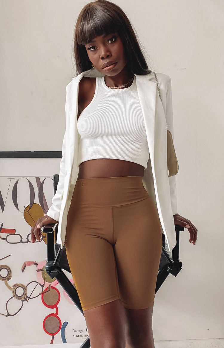 Smooth toffee high-waisted bike shorts with a form-fitting silhouette and mid-thigh length
