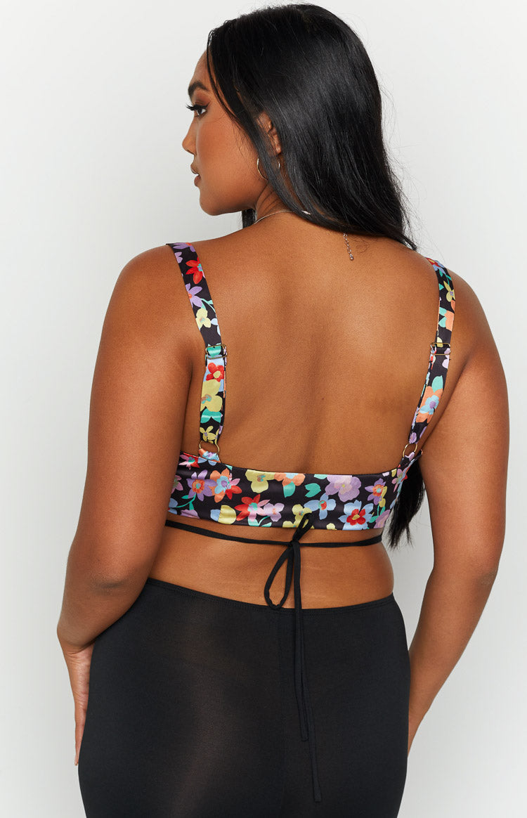 Back view of the black floral corset top featuring a low scoop back and thin tie-back straps