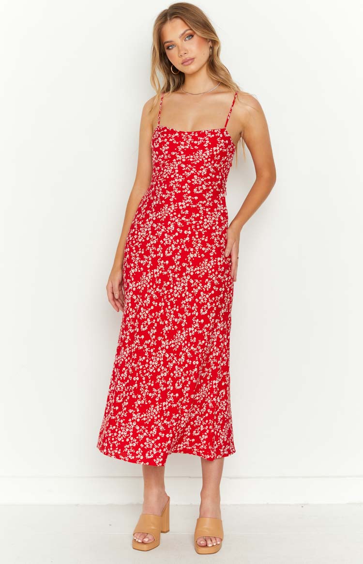 Full length front view of a red floral midi dress with a square neckline, thin straps, and a side slit