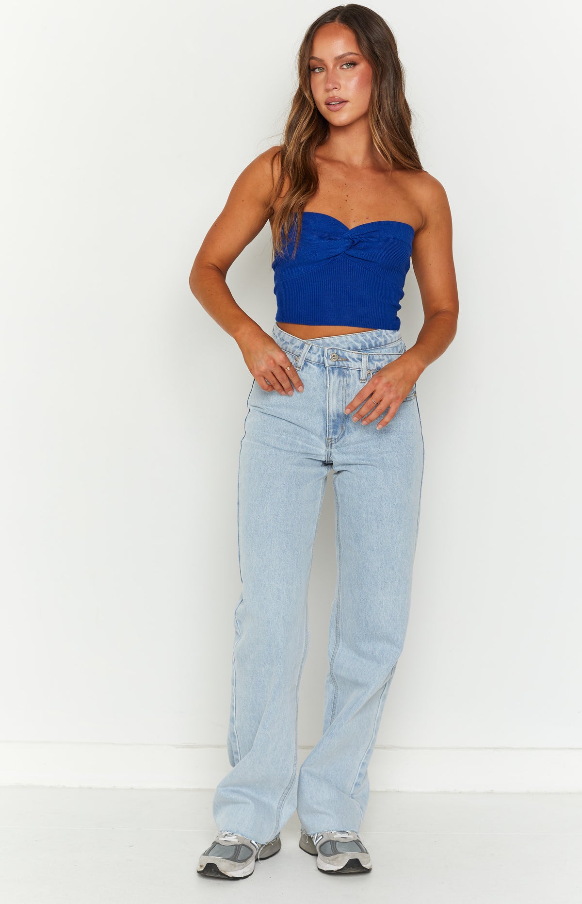Light blue wide leg jeans with an uneven V-shaped waistline and relaxed fit