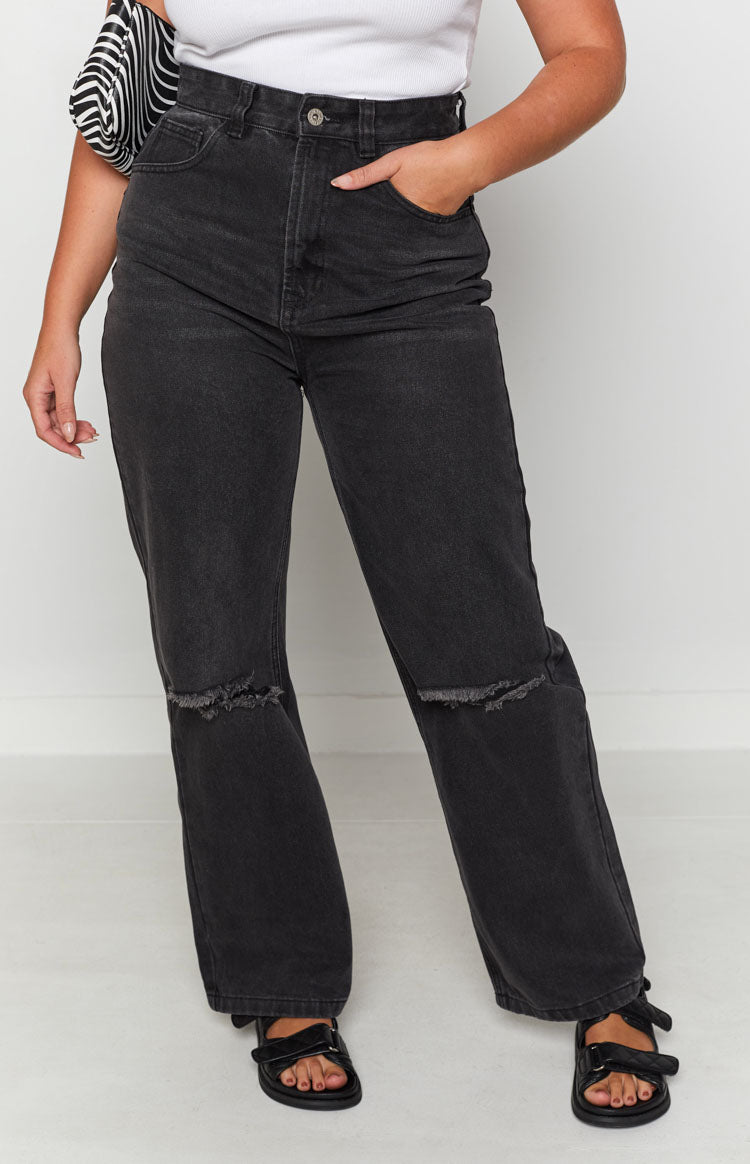Black wash wide leg denim jeans with ripped knees and a high waist