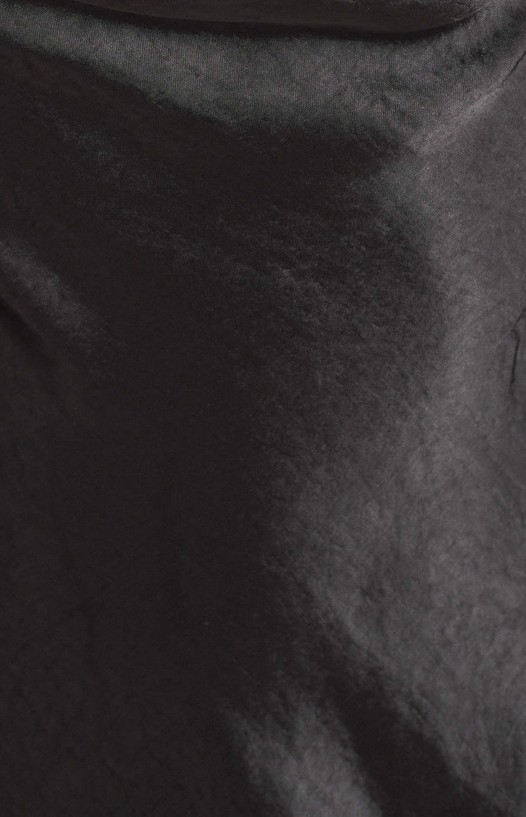 Close-up of the black mini dress fabric, showing its subtle sheen and crinkled texture