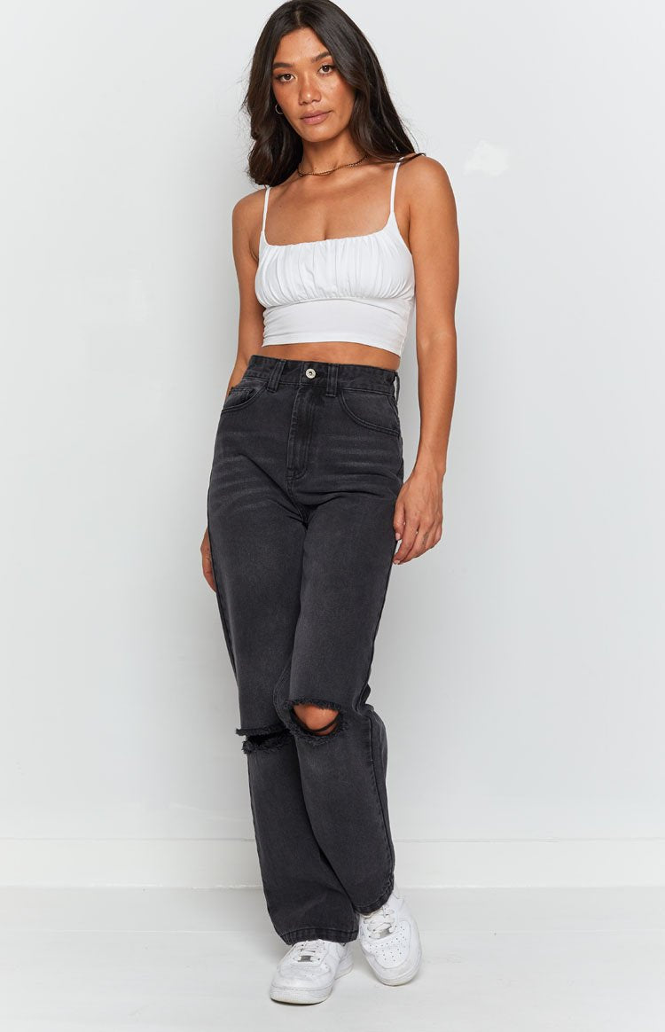 Black wash wide leg jeans with large rips at the knees and a high waist
