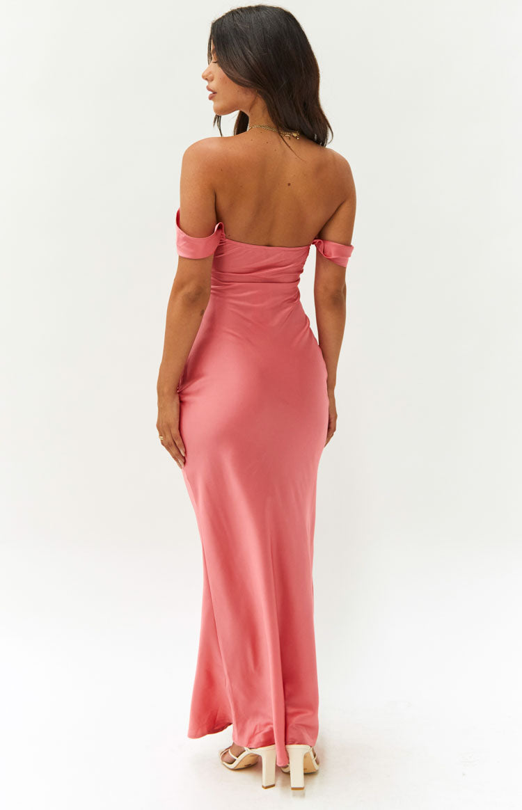 Rear view of a pink off-shoulder formal dress with draped sleeves and a fitted bodice flowing into a maxi skirt