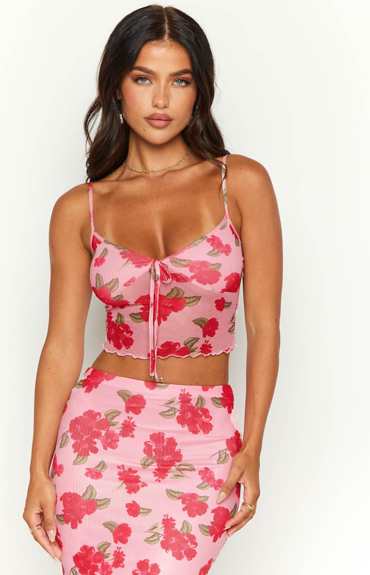 Front view of a pink mesh cami with red floral print, tie-front detail, and scalloped hem