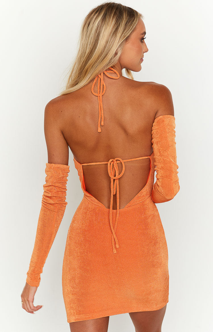 Rear view of an orange shimmery mini dress featuring a halter neck tie, open back with tie closure, and separate ruched long sleeves