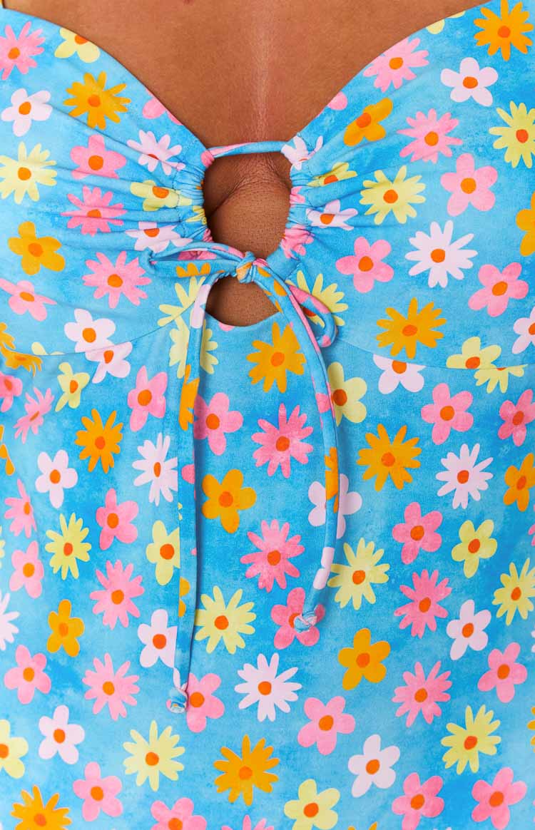 Close-up of the ruched bust with keyhole cutout and tie-front detail on a blue floral one piece