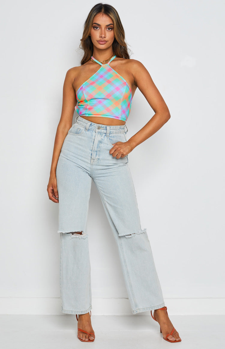 Front view of a blue pink orange and green plaid halter neck crop top with gold chain detail