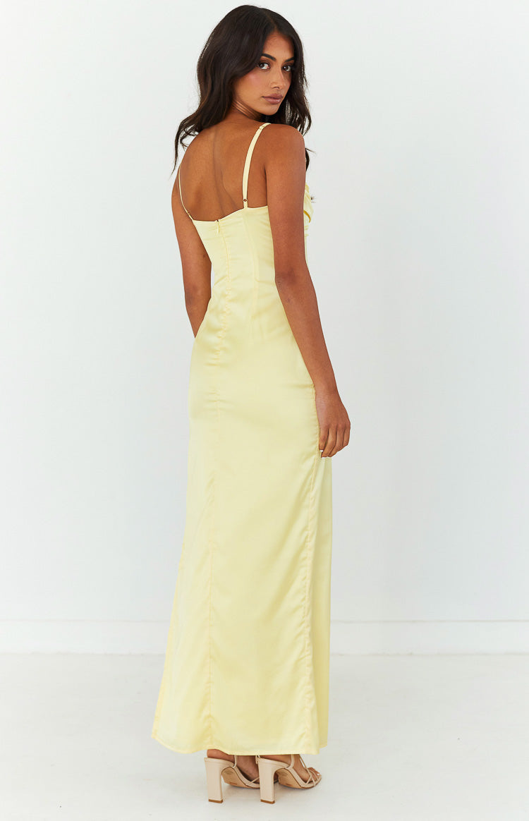 Rear-side view of the honey yellow maxi dress showing the back zipper, thin adjustable straps, and flowing skirt