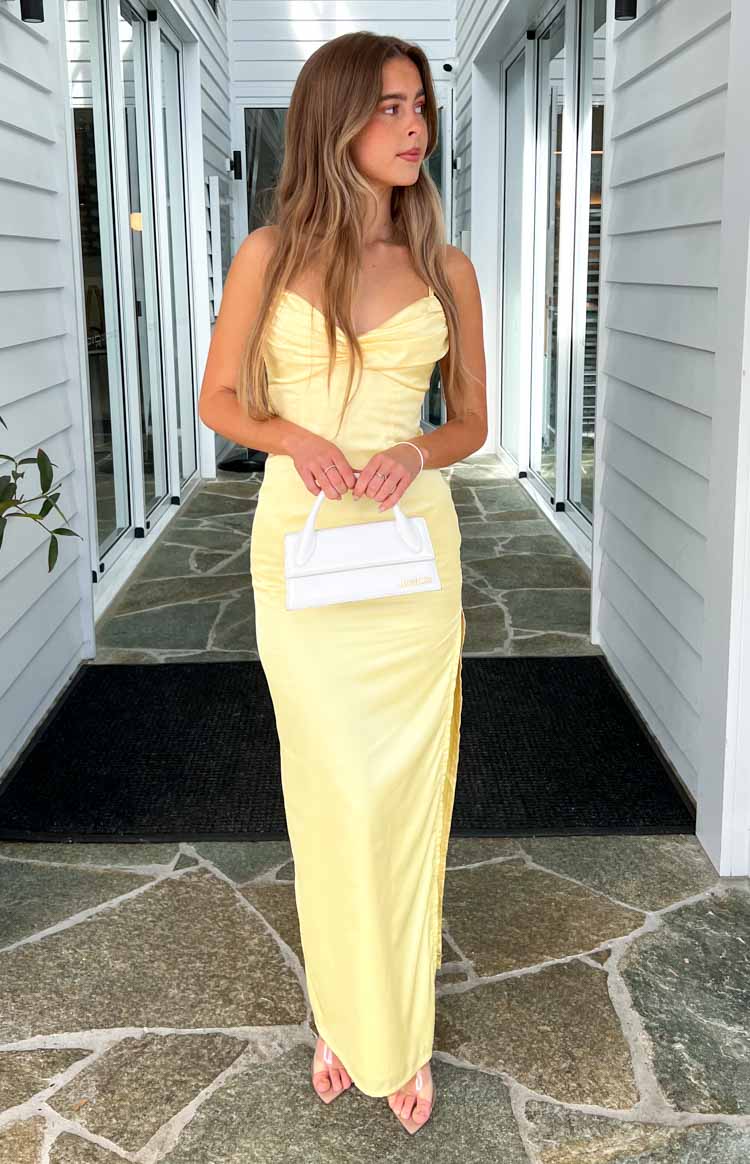 Fitted honey yellow satin maxi dress with a draped cowl neckline and a high ruched side slit