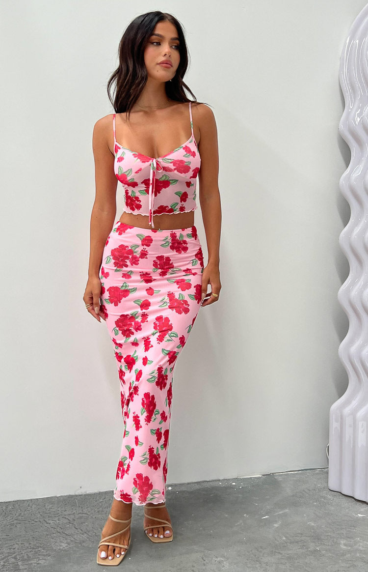 Cropped pink mesh cami with red floral print, cowl neck, spaghetti straps, tie-front, and lettuce hem