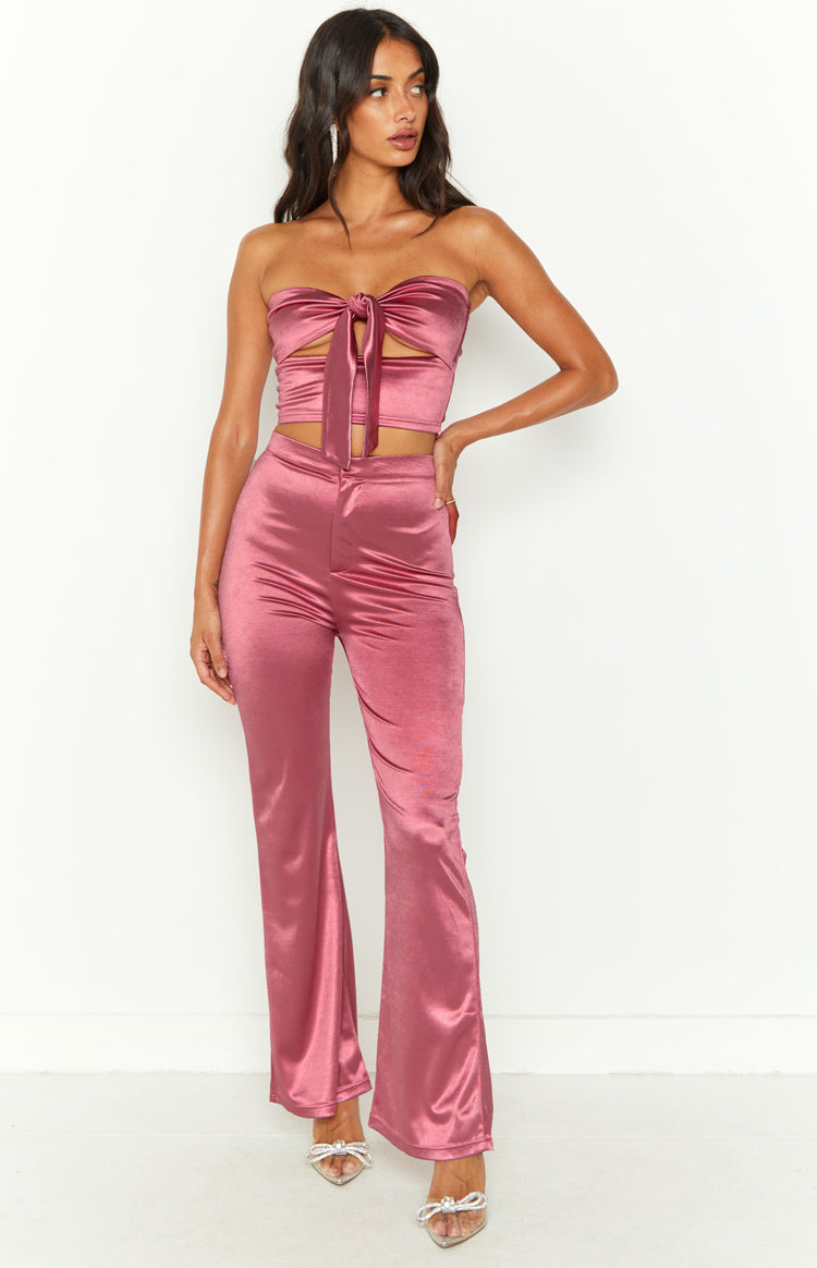 Indigo pink high waisted flare pants, fitted through the thigh and flaring from the knee in a satin-like fabric