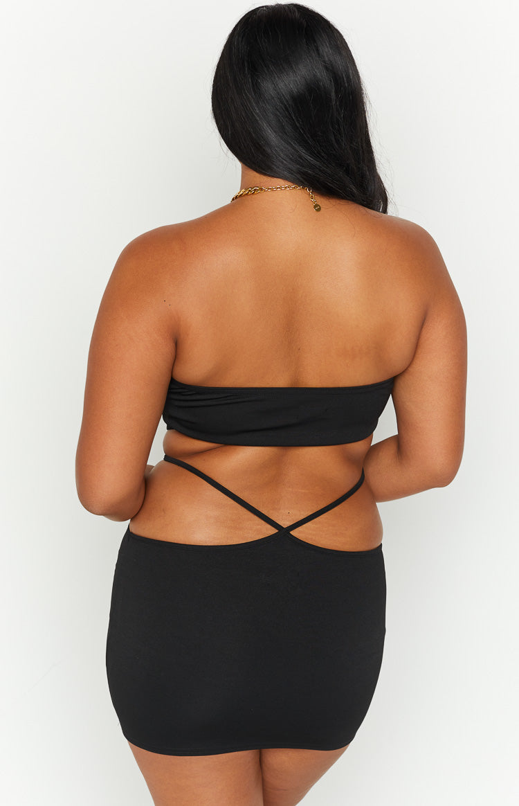 Rear view of a black strapless bandana top with thin criss-cross straps across the lower back
