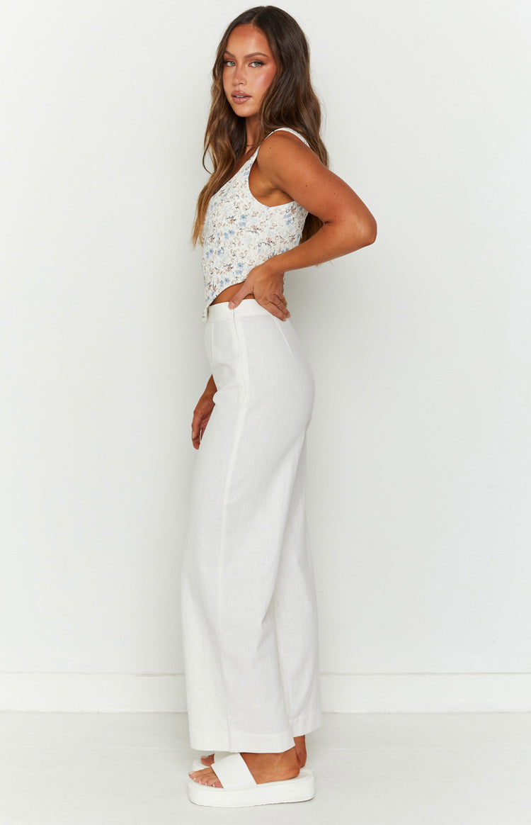White linen pants with a high waist, relaxed wide-leg fit, and full length