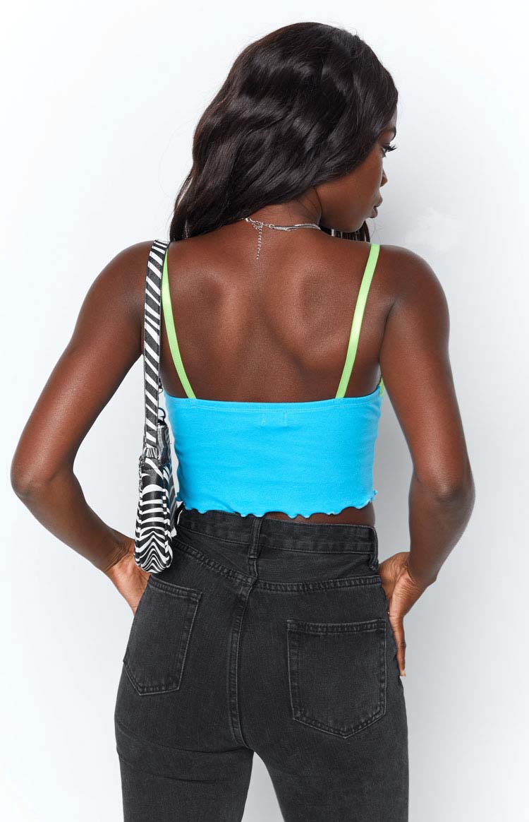 Blue crop tank top with neon green spaghetti straps and a wavy lettuce edge hem