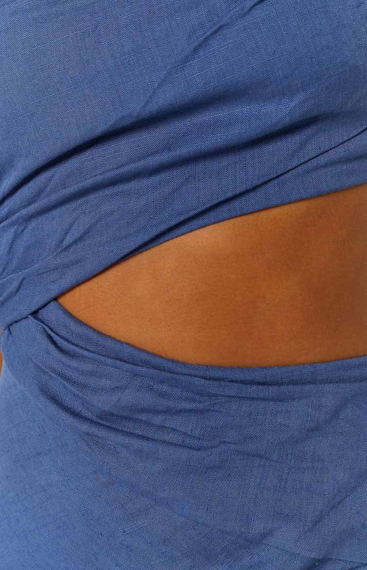 Close-up of the blue linen-blend dress showing a side cutout detail with twisted fabric