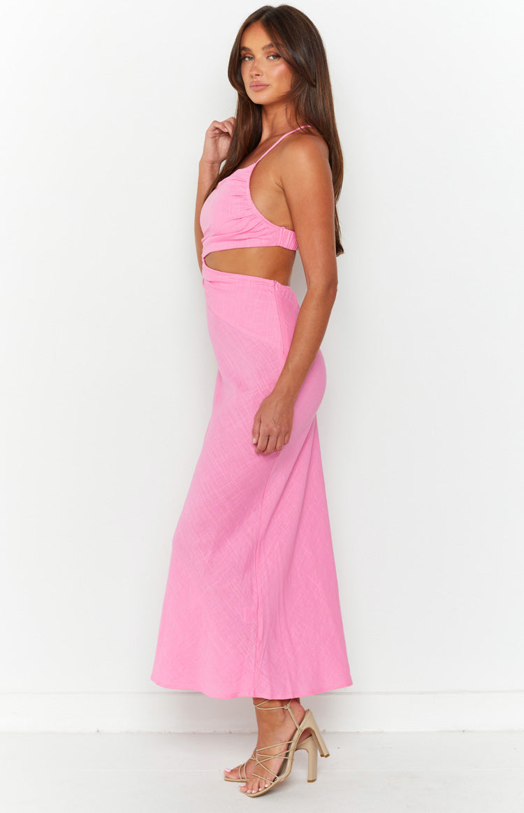 Side view of a pink maxi dress with side cutouts, ruched bust, and a flowy textured skirt