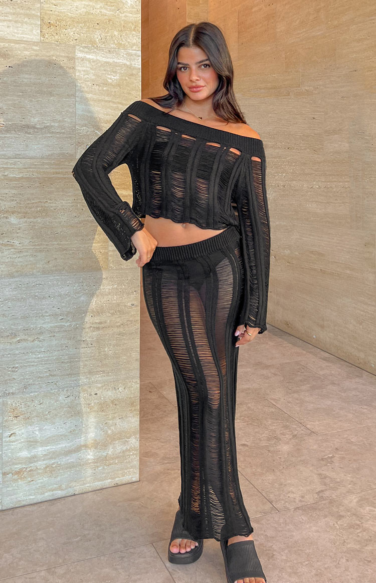 Black ladder knit midi skirt with a ribbed waistband and vertical sheer stripes