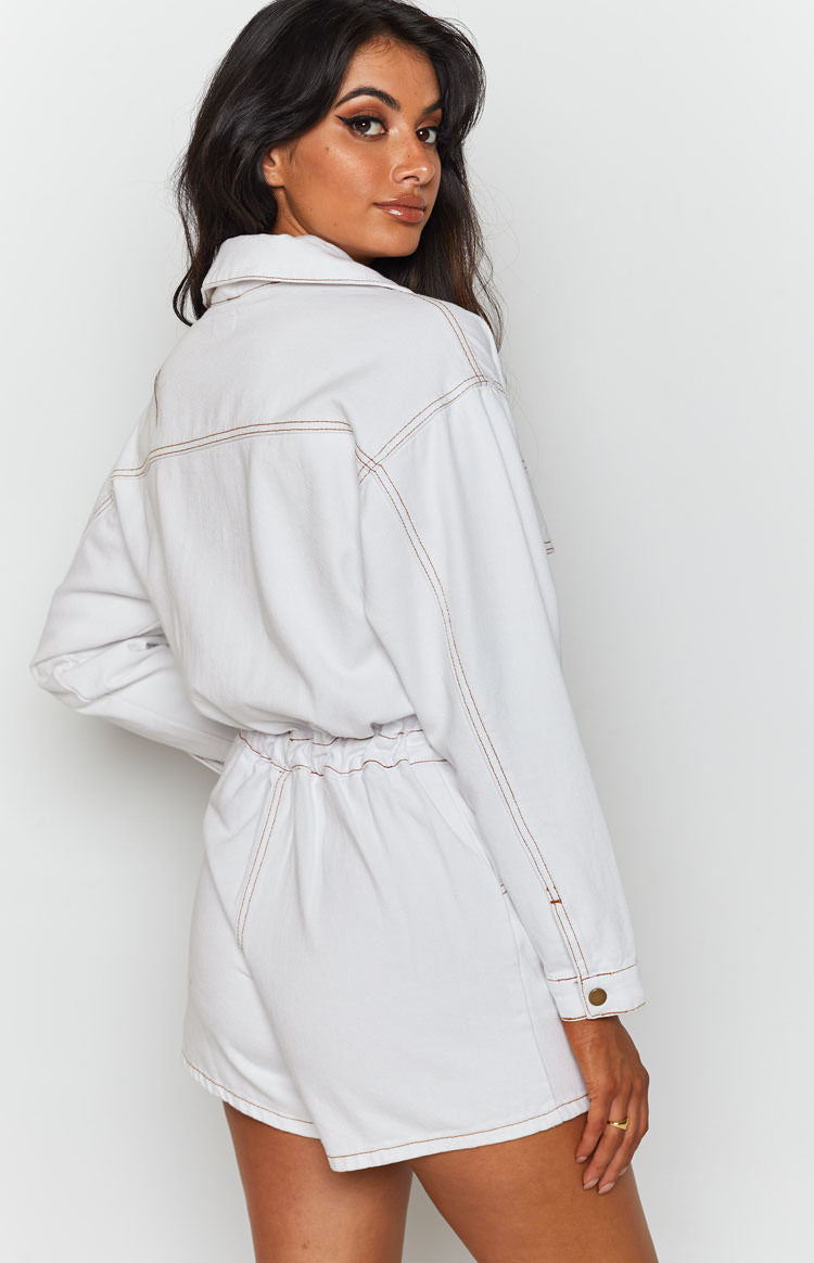 Cream denim playsuit with long sleeves, a collared neckline, brown contrast stitching, and an elasticated waist