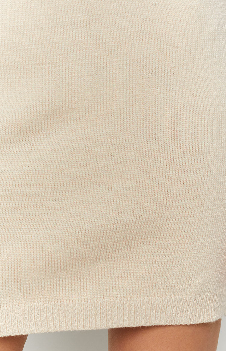 Cream fine gauge knit skirt with a soft texture and ribbed hem