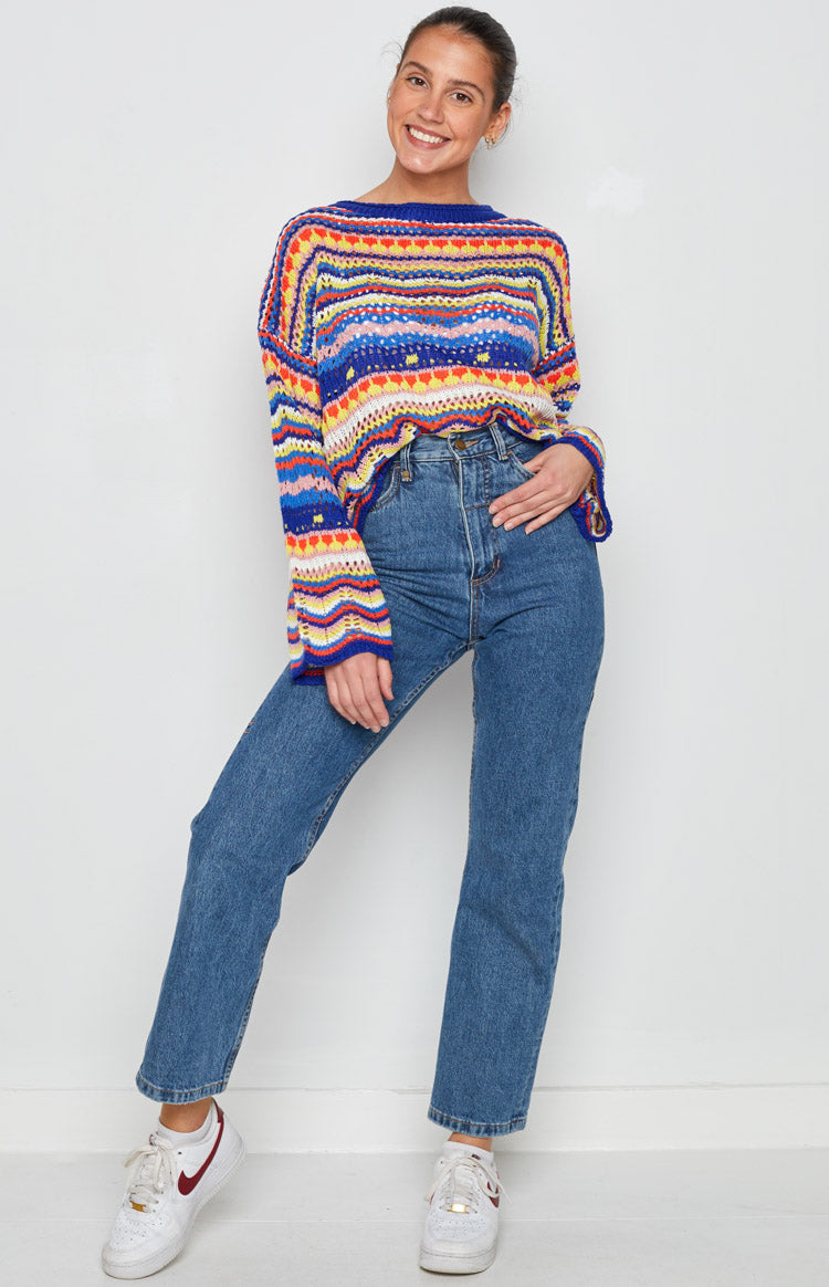 Multicoloured striped knit sweater with a wide boat neckline, long flared sleeves, and open weave texture