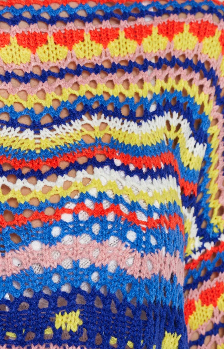Vibrant multi-colour open knit sweater with blue, yellow, red, pink, and white geometric patterns
